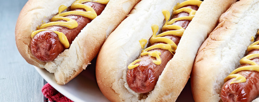 hot dogs in buns with mustard